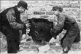 Children Help a Child Out of a Hiding Place, Warsaw Ghetto, Poland. 