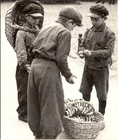 Children selling pretzels, in the Warsaw Ghetto, Poland.